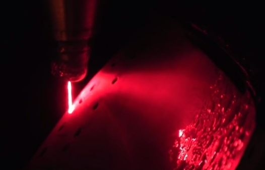 Precise through-hole drilling of a thermal barrier coated GE turbomachinery component