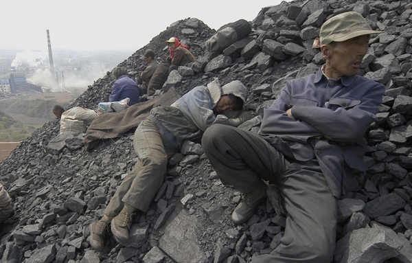 Worker resting at a coal mine in China