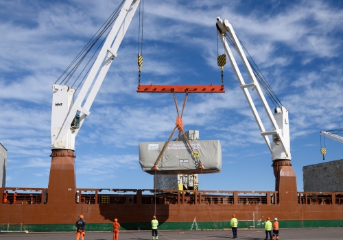 Turbines are loaded on the ship by on-board cranes