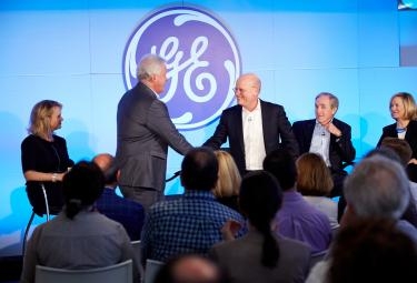 Immelt shakes hands with Flannery, announcing the leadership change effective August 1, 2017