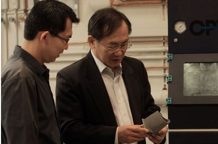 Dr. Chyu (right) examining an investment casting airfoil