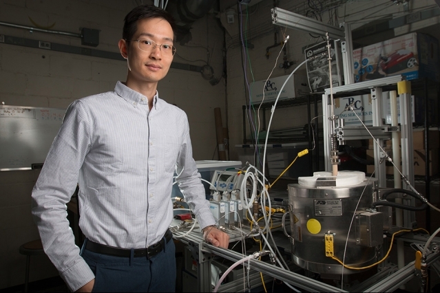 XiaoYu Wu, with the reactor his team used for the research