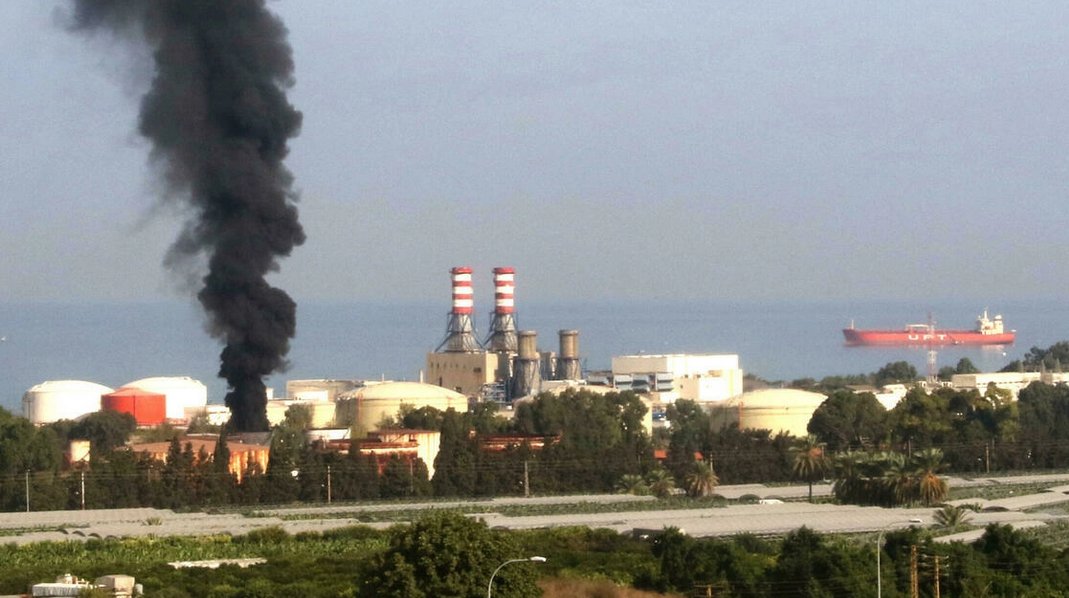 Smoke rises from a fire at a storage tank at Zahrani power plant