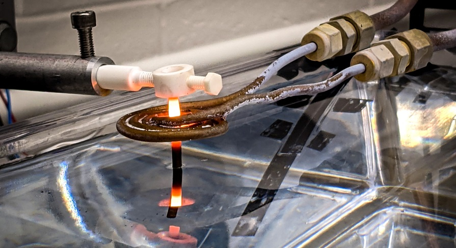 3D-printed superalloy drawn through an induction coil