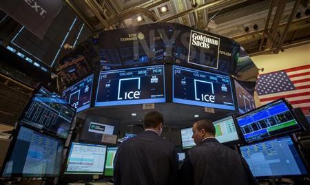 Traders work at the Goldman Sachs post that trades IntercontinentalExchange on the floor of the New York Stock Exchange, November 18, 2013. REUTERS/Brendan McDermid
